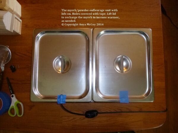Myrrh powder enfleurage trays covered with tape over cutout for power cord.